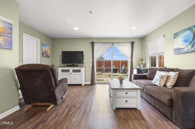 living room featuring dark wood-type flooring, recessed lighting, and baseboards