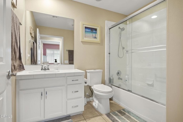 full bathroom featuring tile patterned floors, visible vents, toilet, combined bath / shower with glass door, and vanity