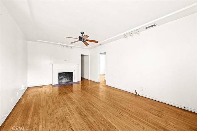 unfurnished living room with hardwood / wood-style floors and ceiling fan