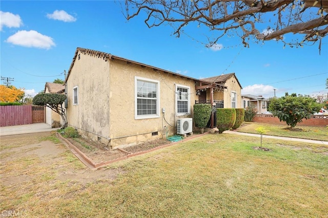 view of home's exterior featuring ac unit and a lawn