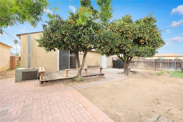 back of house with cooling unit, a patio area, and a wooden deck