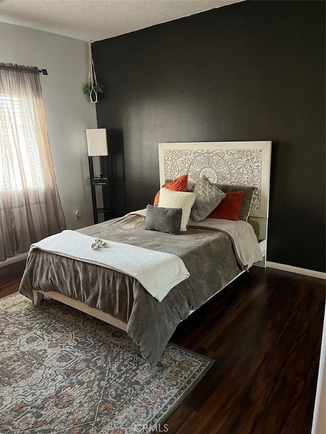 bedroom featuring hardwood / wood-style floors and a textured ceiling