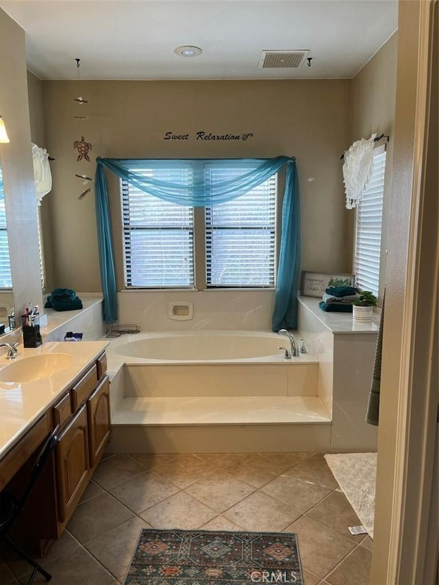 bathroom featuring a tub, tile patterned flooring, and vanity