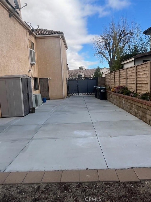 view of patio with an AC wall unit