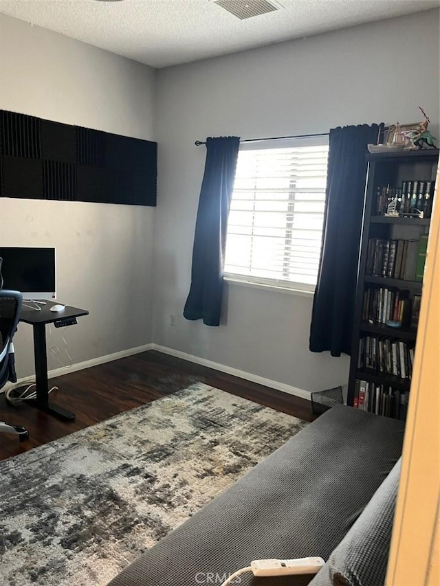 office space featuring a textured ceiling, ceiling fan, and dark wood-type flooring