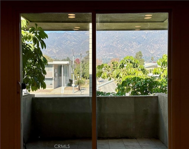 entryway with a mountain view and light tile patterned floors