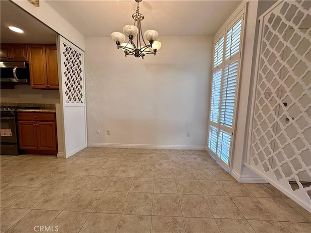 unfurnished dining area featuring a chandelier and light tile patterned floors