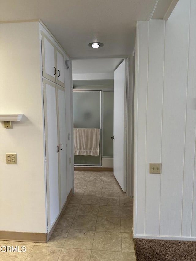 corridor featuring light tile patterned flooring