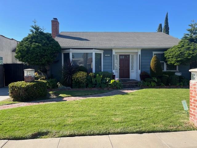 205 S Poinsettia Ave, Compton, CA 90221 - view of front of property featuring a front lawn and a chimney