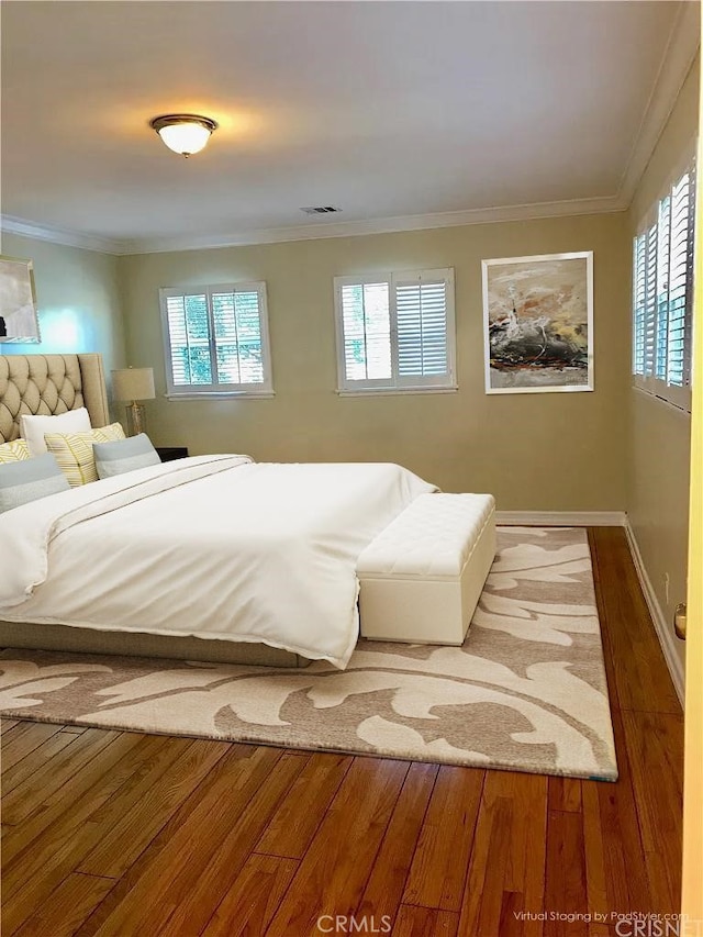 bedroom featuring crown molding and hardwood / wood-style floors