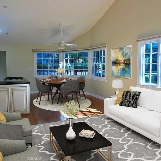 living room featuring hardwood / wood-style flooring, high vaulted ceiling, and ceiling fan