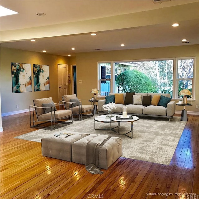 living room featuring hardwood / wood-style floors and a healthy amount of sunlight