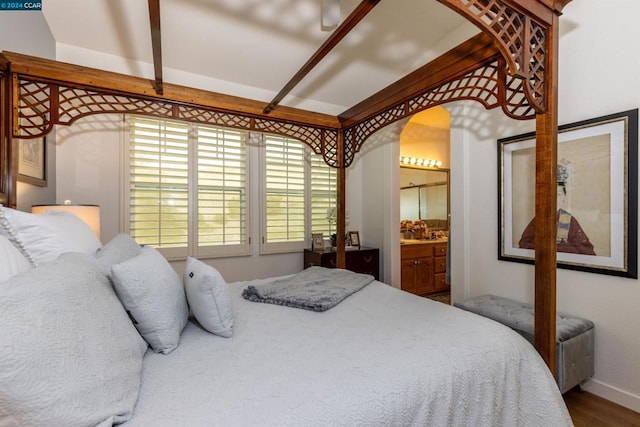 bedroom featuring hardwood / wood-style floors and connected bathroom