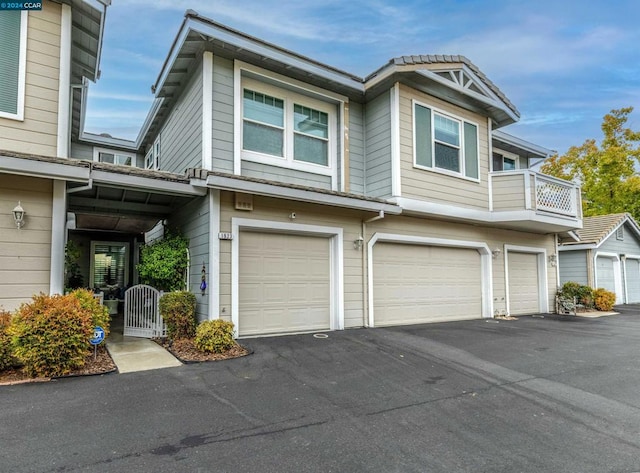 townhome / multi-family property with a balcony and a garage