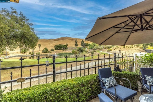 view of patio with a water and mountain view