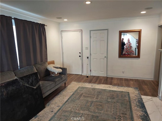 living room featuring ornamental molding and wood-type flooring