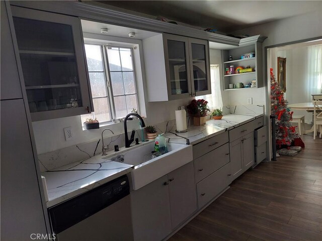 kitchen featuring white cabinetry, dishwasher, sink, dark hardwood / wood-style flooring, and light stone countertops