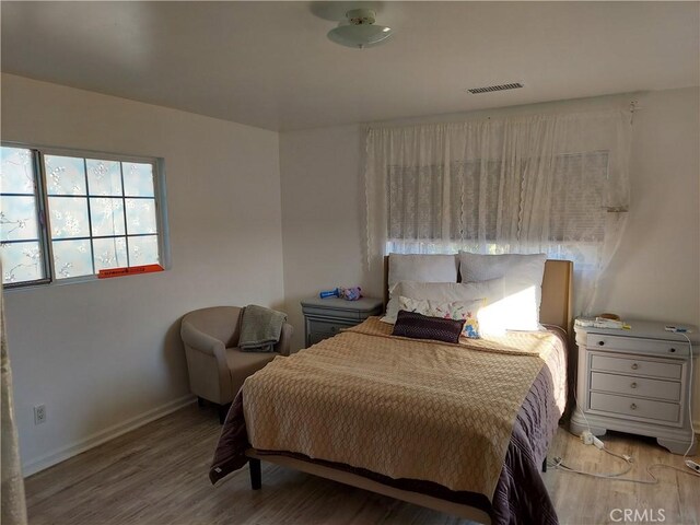 bedroom with light hardwood / wood-style flooring