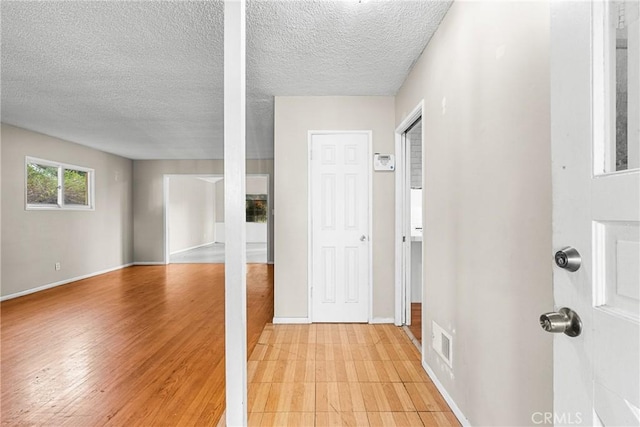 corridor featuring a textured ceiling