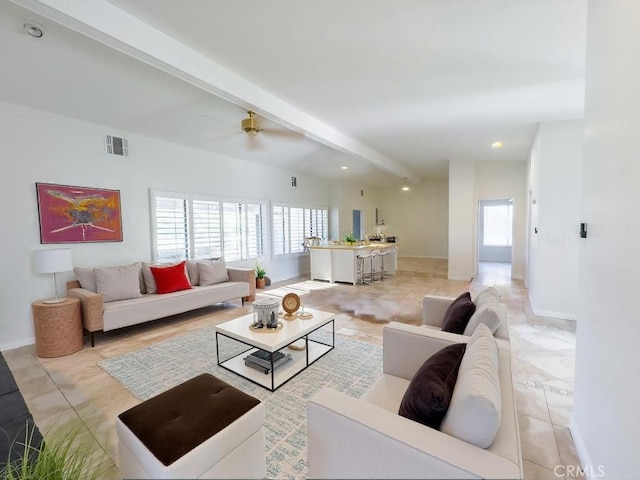 living room featuring ceiling fan and beam ceiling