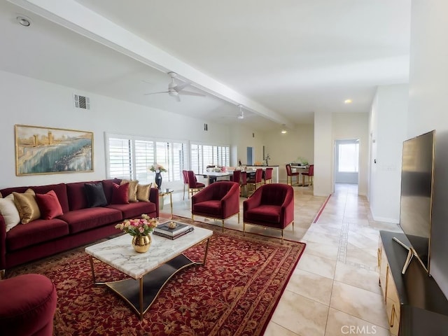 living room featuring ceiling fan, beamed ceiling, and light tile patterned flooring