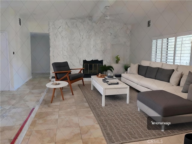 living room featuring tile walls and a fireplace