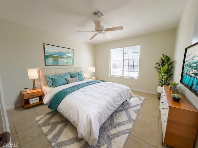 bedroom with ceiling fan and light tile patterned flooring