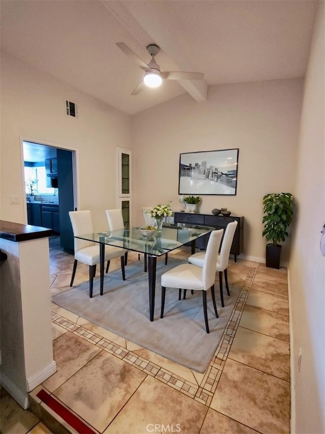 dining space with ceiling fan and vaulted ceiling with beams