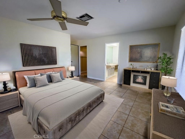 tiled bedroom with ceiling fan and ensuite bathroom