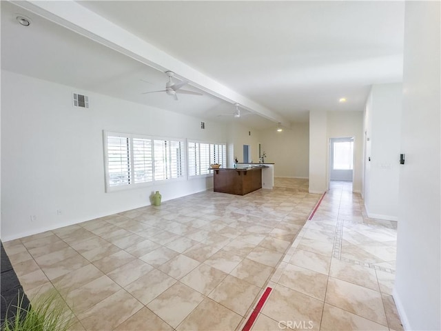 kitchen with ceiling fan and lofted ceiling with beams