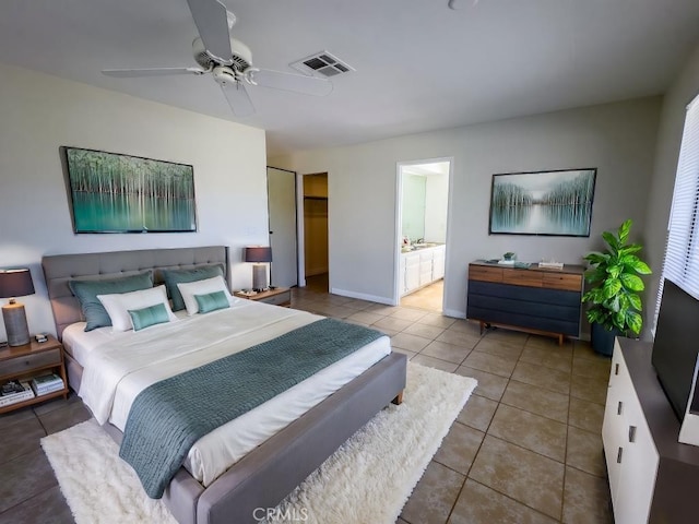 bedroom featuring ensuite bathroom, ceiling fan, and tile patterned flooring