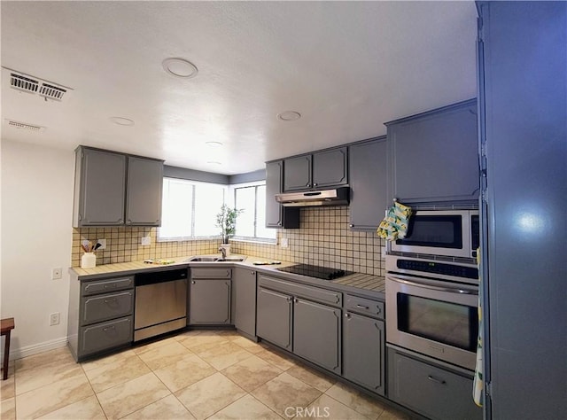 kitchen featuring sink, gray cabinets, and stainless steel appliances