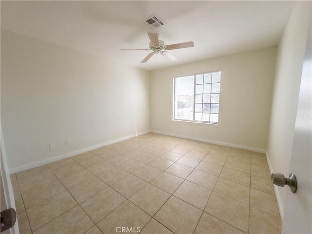 empty room featuring ceiling fan and light tile patterned floors