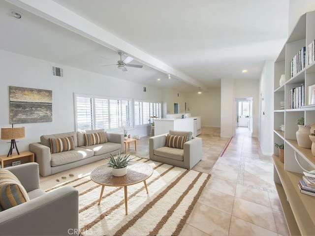 tiled living room featuring ceiling fan and beamed ceiling