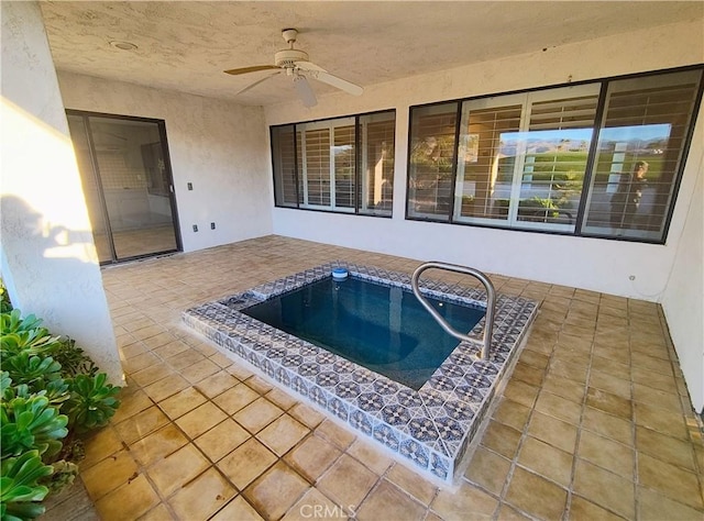 view of pool with ceiling fan, a hot tub, and a patio