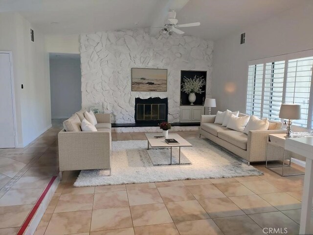 unfurnished living room with ceiling fan, light tile patterned floors, and a fireplace