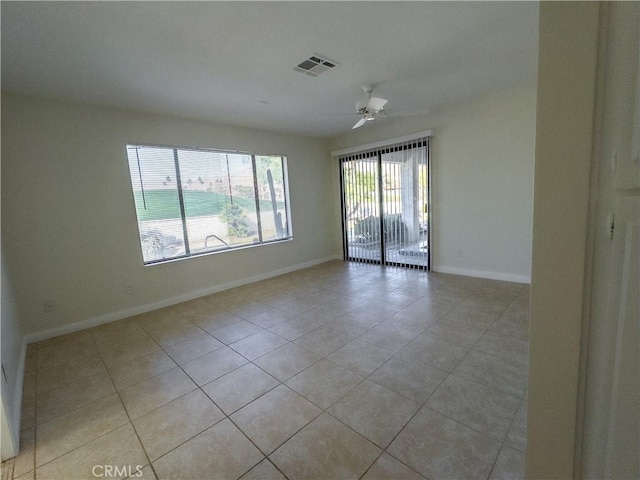 unfurnished room featuring ceiling fan and light tile patterned floors