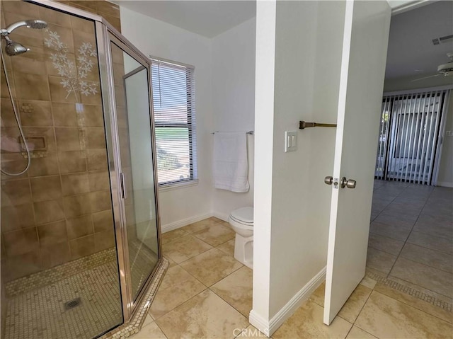 bathroom featuring toilet, tile patterned flooring, a shower with shower door, and ceiling fan