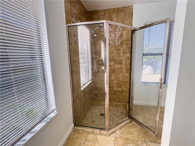 bathroom with walk in shower and tile patterned flooring