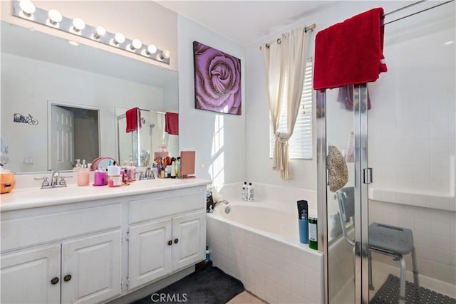 bathroom featuring vanity and separate shower and tub