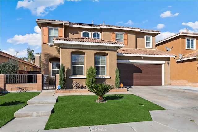 mediterranean / spanish home with a front yard and a garage