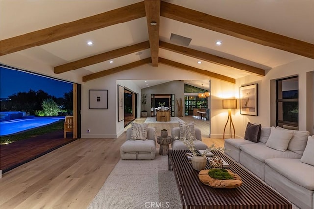 living room with lofted ceiling with beams, a notable chandelier, and light hardwood / wood-style floors