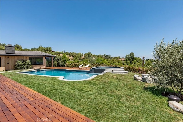 view of pool with an in ground hot tub and a lawn