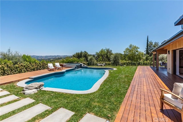 view of swimming pool with an in ground hot tub, a deck, and a lawn