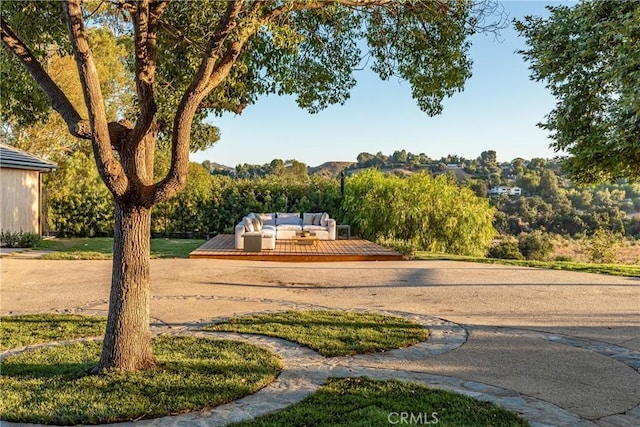 view of community with a wooden deck and an outdoor living space