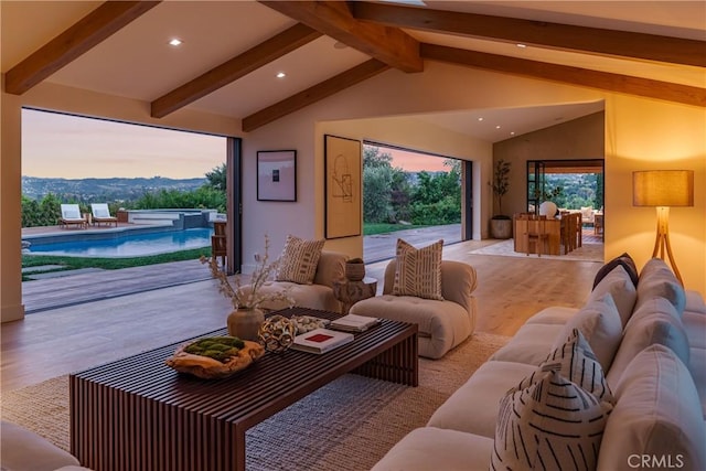 cinema with lofted ceiling with beams and light hardwood / wood-style floors