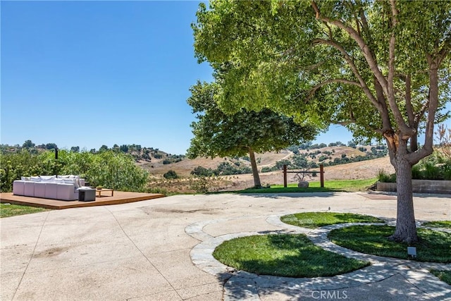 surrounding community featuring a patio area and a deck with mountain view