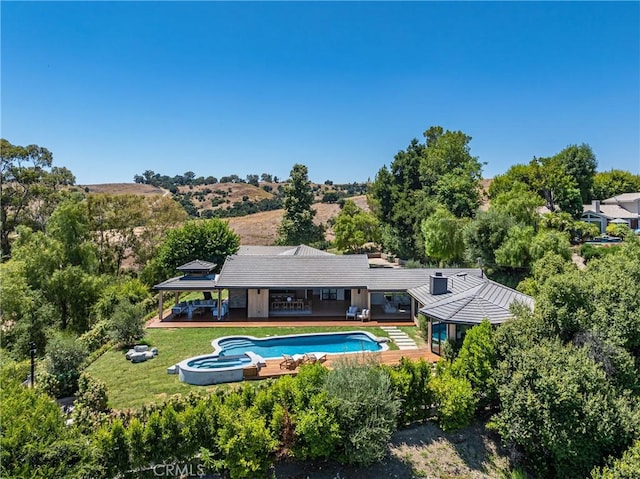 exterior space featuring a yard and a pool side deck