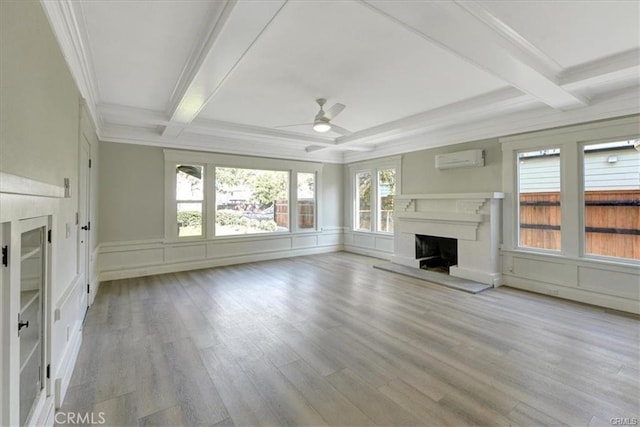 unfurnished living room featuring light hardwood / wood-style flooring, an AC wall unit, ceiling fan, and crown molding