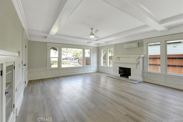 1048 E 5th St, Long Beach, CA 90802 - unfurnished living room featuring ceiling fan, an AC wall unit, beamed ceiling, a fireplace with raised hearth, and coffered ceiling